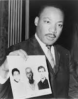 Martin Luther King holds flyer for Schwerner, Goodman and Chaney